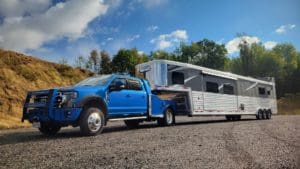 A fifth wheel hauler truck by Utility Bodywerks is the perfect hauler truck for transporting precious cargo, like the horses that will travel in this horse trailer.