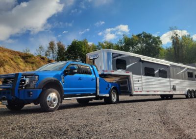 A fifth wheel hauler truck by Utility Bodywerks is the perfect hauler truck for transporting precious cargo, like the horses that will travel in this horse trailer.