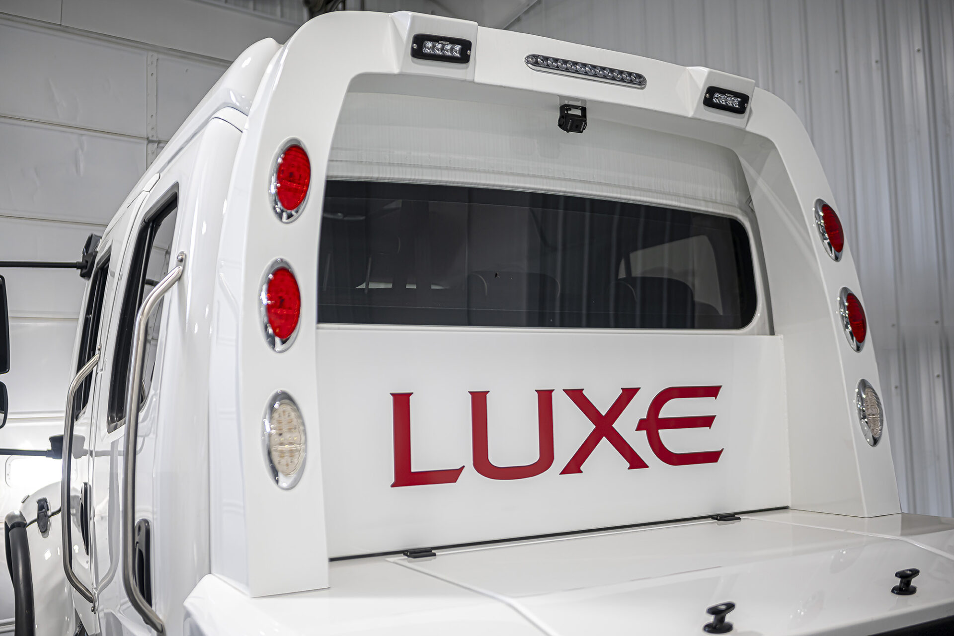 White Freightliner M2-106 with a hauler body build by Luxe Trucks in Elkhart, Indiana.